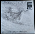 A vinyl record sleeve for the album 'The Cloud of Unknowing' by Sepultura, featuring a grayscale sketch of a skeletal figure on a light gray background, photographed on a light wood surface.